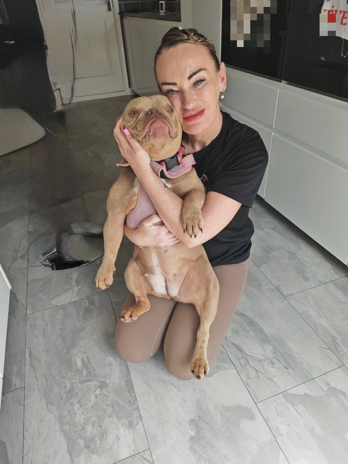 Mandi, founder of Homeward Houndz, holding Rosie